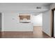 Bright living room with wood floors, a pass through to the kitchen, and natural light at 7665 E Eastman Ave # D304, Denver, CO 80231