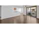 Bright living room with wood floors, a pass through to the kitchen and sliding glass door to the patio at 7665 E Eastman Ave # D304, Denver, CO 80231