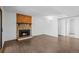 Spacious living room with a stone fireplace, hardwood floors, and neutral walls at 7665 E Eastman Ave # D304, Denver, CO 80231