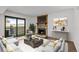 Inviting living room featuring a stone fireplace, stylish furniture, and access to an outdoor patio at 7665 E Eastman Ave # D304, Denver, CO 80231