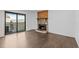 Living room featuring a stone fireplace, sliding glass doors to a patio, and modern wood-look floors at 7665 E Eastman Ave # D304, Denver, CO 80231