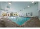Indoor swimming pool with lounge chairs and ample lighting for year-round enjoyment at 7665 E Eastman Ave # D304, Denver, CO 80231