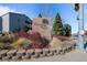 Stone sign for Shadow Wood with plants and flowers at 7665 E Eastman Ave # D304, Denver, CO 80231