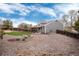 A house's exterior features a covered patio, landscaping, and gravel at 13093 Hudson St, Thornton, CO 80241