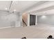 Expansive basement area with plush carpet, a small refrigerator, and potential for versatile use at 13093 Hudson St, Thornton, CO 80241