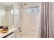 Bathroom with a shower and tub, window, and tile at 13093 Hudson St, Thornton, CO 80241