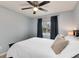 Cozy bedroom with a ceiling fan and a window with dark curtains at 13093 Hudson St, Thornton, CO 80241
