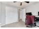Bedroom with a ceiling fan, closet, door, desk, and chair at 13093 Hudson St, Thornton, CO 80241