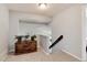 Hallway with carpet, wooden chest, and view of staircase at 13093 Hudson St, Thornton, CO 80241