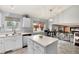 Bright kitchen features white cabinetry, stainless steel appliances, and an island with extra counter space at 13093 Hudson St, Thornton, CO 80241