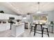 Bright kitchen with white cabinetry, stainless steel appliances, an island, and an adjacent dining area at 13093 Hudson St, Thornton, CO 80241
