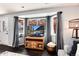 Comfortable living room area with a bay window with wooden accents and stylish wooden TV stand at 13093 Hudson St, Thornton, CO 80241