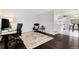 Open living space featuring dark wood floors, neutral walls, and views into the adjacent kitchen at 13093 Hudson St, Thornton, CO 80241