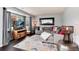 Cozy living room features a comfortable gray sofa, colorful rug, and large windows for natural light at 13093 Hudson St, Thornton, CO 80241