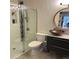 Modern bathroom featuring a glass shower, textured walls, and a stylish vessel sink at 4878 E Kentucky Ave # A, Denver, CO 80246