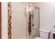 Modern bathroom showcasing the glass-enclosed shower with mosaic accents and textured tile walls at 4878 E Kentucky Ave # A, Denver, CO 80246