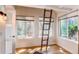 Charming bedroom with a unique ladder feature, hardwood floors, and bright windows for natural light at 4878 E Kentucky Ave # A, Denver, CO 80246