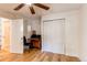Bright bedroom features wood floors, a ceiling fan, and sliding door closet at 4878 E Kentucky Ave # A, Denver, CO 80246