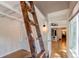 The guest room has an decorative ladder providing access to a loft or storage and light neutral walls at 4878 E Kentucky Ave # A, Denver, CO 80246