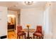Cozy dining area features an antique table set, chandelier, and a glimpse of the adjacent bathroom at 4878 E Kentucky Ave # A, Denver, CO 80246