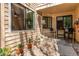 Charming exterior with stone accents, decorative plants, and a front porch seating area at 4878 E Kentucky Ave # A, Denver, CO 80246