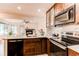 A modern kitchen features stainless steel appliances, ample counter space, and rich wooden cabinetry at 4878 E Kentucky Ave # A, Denver, CO 80246