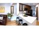 Bright, open kitchen with breakfast bar, sleek countertops, and stainless steel appliances at 4878 E Kentucky Ave # A, Denver, CO 80246
