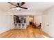 Living room open to the kitchen and dining area with hardwood floors and lots of light at 4878 E Kentucky Ave # A, Denver, CO 80246