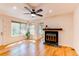 Bright living room with large windows, wood floors, and a fireplace with a dark wood mantel at 4878 E Kentucky Ave # A, Denver, CO 80246