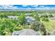 Scenic aerial view of a blue apartment building surrounded by lush greenery and mountain views at 8065 W Eastman Pl # 6-102, Denver, CO 80227