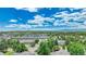 Scenic aerial view of the neighborhood featuring lush greenery and mountain views in the distance at 8065 W Eastman Pl # 6-102, Denver, CO 80227