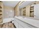 Well-lit bathroom features a single sink vanity, bathtub with shower, and closet at 8065 W Eastman Pl # 6-102, Denver, CO 80227
