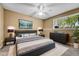 Comfortable bedroom with neutral tones features a ceiling fan, window, and stylish decor at 8065 W Eastman Pl # 6-102, Denver, CO 80227