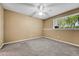 Cozy bedroom featuring neutral walls, plush carpeting, and natural light through window at 8065 W Eastman Pl # 6-102, Denver, CO 80227