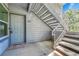 Condo entrance featuring unit number 102, with stairs to an upper level at 8065 W Eastman Pl # 6-102, Denver, CO 80227