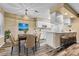 Dining area with open kitchen, island seating, stainless appliances, and lots of light at 8065 W Eastman Pl # 6-102, Denver, CO 80227