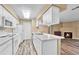 Kitchen with updated flooring, lots of counter space, white cabinets, and stainless appliances at 8065 W Eastman Pl # 6-102, Denver, CO 80227