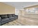 Open concept living room with kitchen view, wood floors, neutral paint, and lots of light at 8065 W Eastman Pl # 6-102, Denver, CO 80227