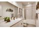 Beautiful bathroom features a shower-tub combo, decorative mirror and modern fixtures at 13806 Honey Hush Trl, Parker, CO 80134