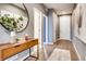 Inviting hallway featuring wood floors, neutral gray walls, modern decor, and multiple doors leading to various rooms at 13806 Honey Hush Trl, Parker, CO 80134