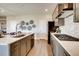 Sleek kitchen with modern appliances, white countertops, gray cabinets, and a stylish backsplash at 13806 Honey Hush Trl, Parker, CO 80134