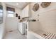 Bright laundry room with modern appliances and a convenient dog washing station at 13806 Honey Hush Trl, Parker, CO 80134