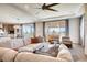 Open-concept living room with comfortable seating, large windows with scenic views, and stylish modern décor at 13806 Honey Hush Trl, Parker, CO 80134