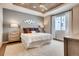 Serene bedroom with a wood plank ceiling, neutral colors, plush bedding, and stylish decor at 13806 Honey Hush Trl, Parker, CO 80134