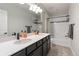 Bright bathroom features double sinks, modern fixtures, tiled shower and backsplash, and sleek design at 15565 E 115Th Ave, Commerce City, CO 80022