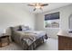 Cozy bedroom with neutral tones, carpet, ceiling fan, and natural light from the window, creating a relaxing atmosphere at 15565 E 115Th Ave, Commerce City, CO 80022