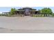 Attractive clubhouse with outdoor patio, manicured landscaping, and convenient parking at 15565 E 115Th Ave, Commerce City, CO 80022