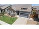 Charming single-Gathering home exterior, highlighted by a manicured lawn and a spacious driveway, offering great curb appeal at 15565 E 115Th Ave, Commerce City, CO 80022