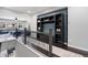 Open hallway featuring a built-in shelving unit and view to the living room, highlighting the home's layout at 15565 E 115Th Ave, Commerce City, CO 80022