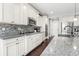 Modern kitchen features granite countertops, stainless steel appliances, and tile backsplash at 15565 E 115Th Ave, Commerce City, CO 80022